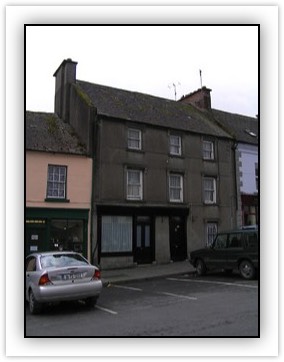 Heneghans Main Street, Fethard, Tipperary South 	Terraced three-bay three-storey house, built c. 1900, with disused shopfront and with projecting single-bay extension to first floor rear elevation with corrugated-iron walls and lean-to artificial slate roof. Pitched slate roof with rendered chimne...