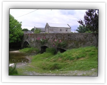 Four-arch road bridge over River Clashawley, built c. 1500, with roughly dressed V-cutwaters to west elevation, round arches to south, southmost being narrower, and camber arches to north, northmost arch being dry. 